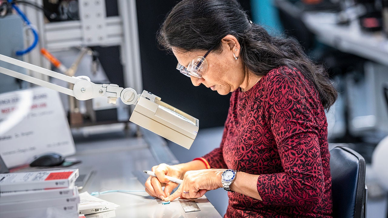 Manufacturing employee reviewing production materials in a facility.