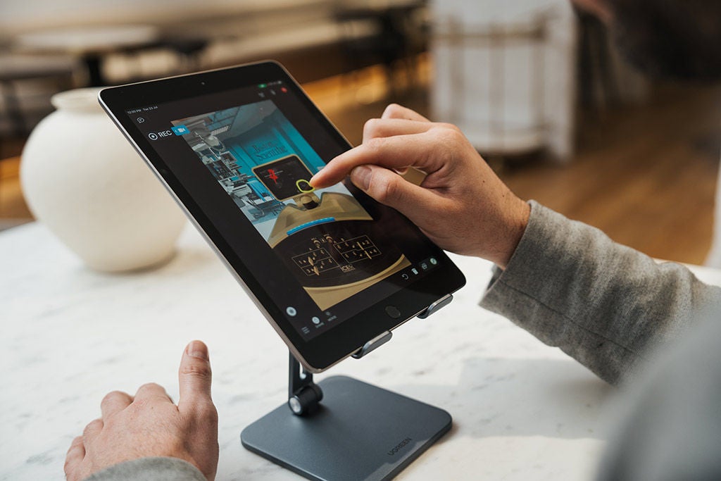 Finger operating a tablet device