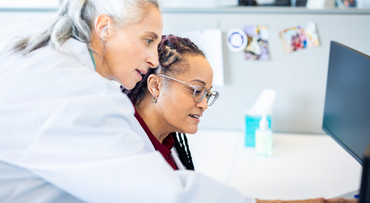 Two physicians looking at computer