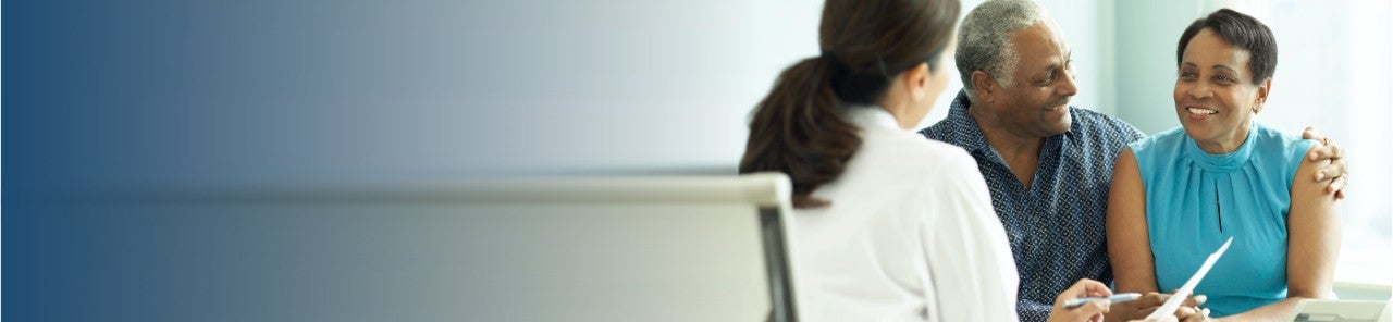 Doctor consulting with patient and patient's spouse.