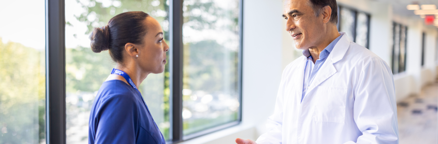 Boston Scientific rep talks with physician.