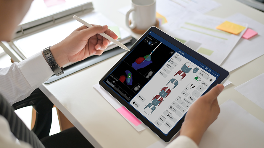 Person using Boston Scientific’s Directional DBS system on a table with a stylus