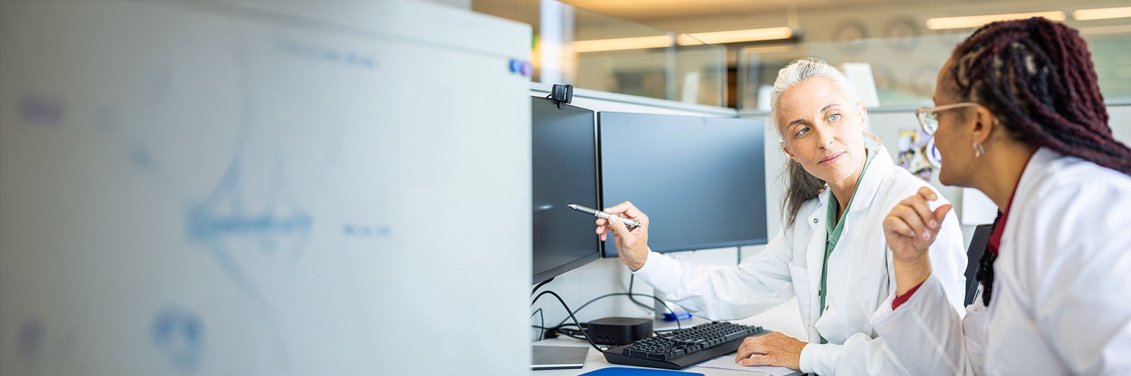 Two female healthcare workers looking at a monitor.