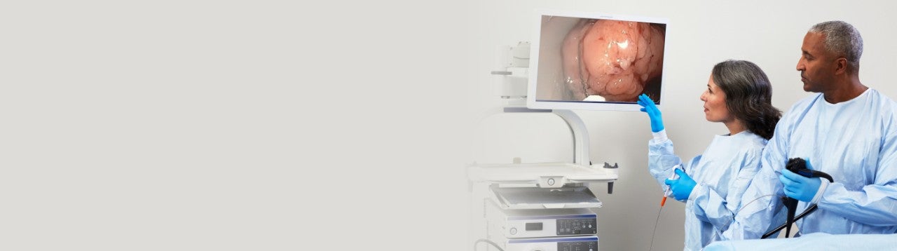 two health care professionals viewing and endoscopic mucosal resection on a monitor