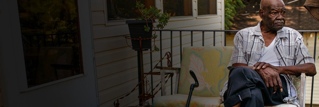 Man with crossed legs resting on porch