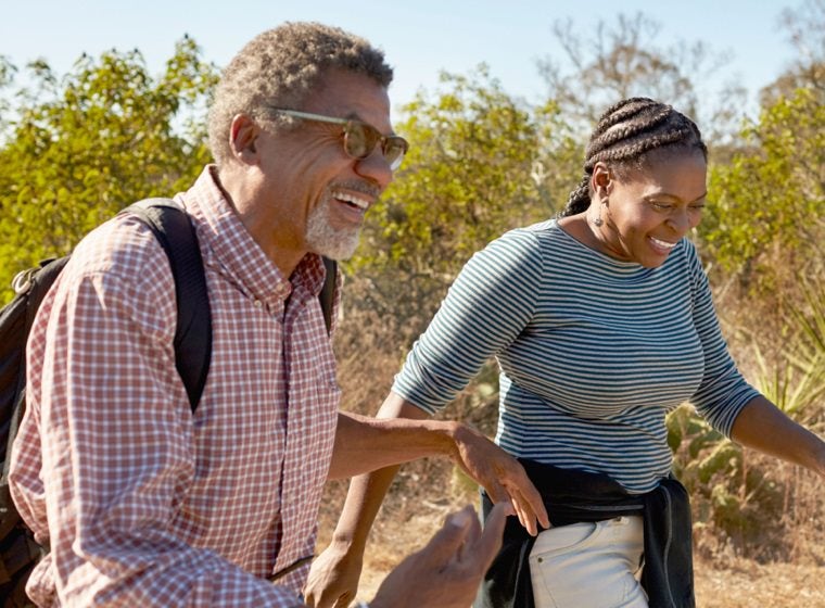 Man and woman smiling and walking in the outdoors