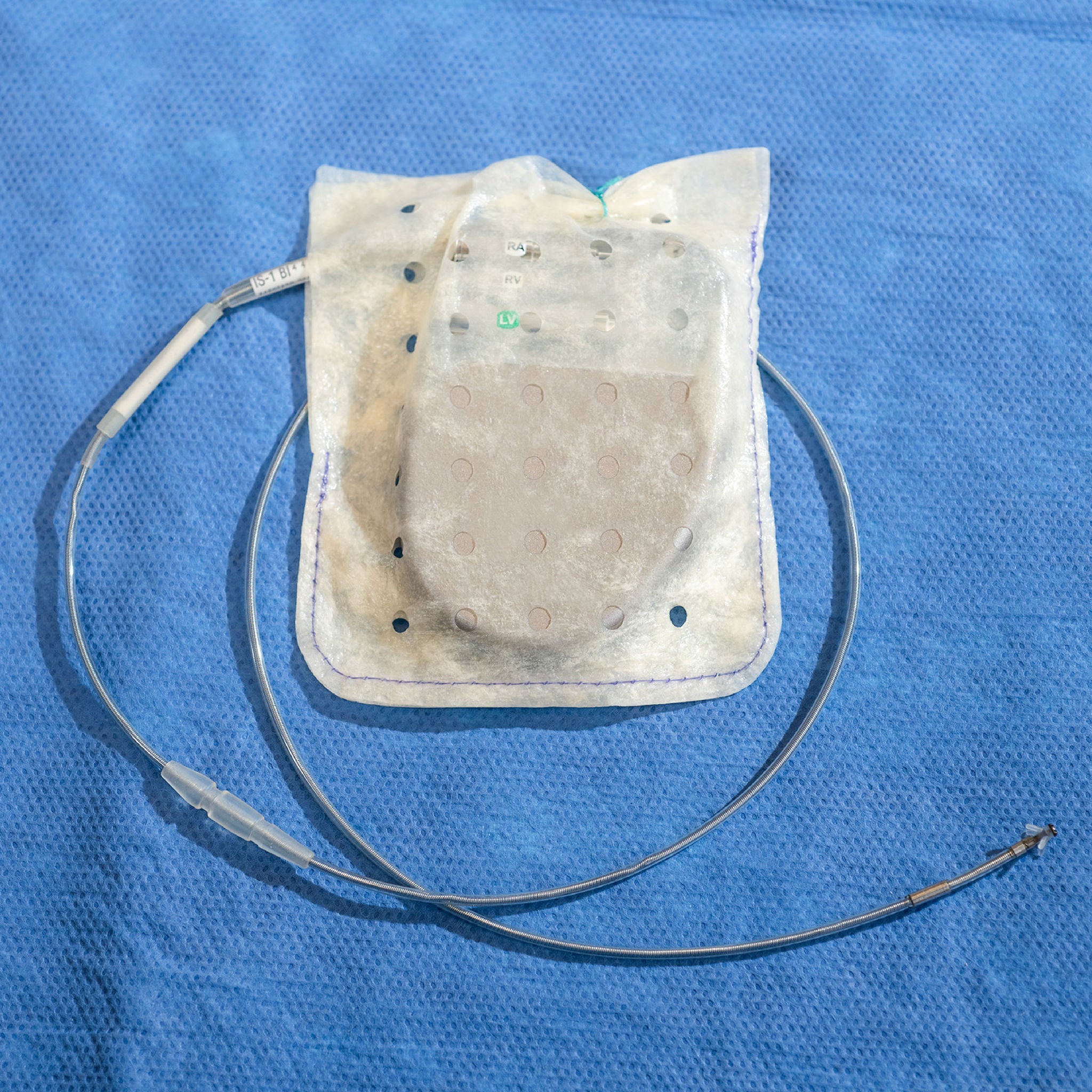 A hydrated envelope wrapped around the battery of a dual chamber pacemaker on a surgical table.