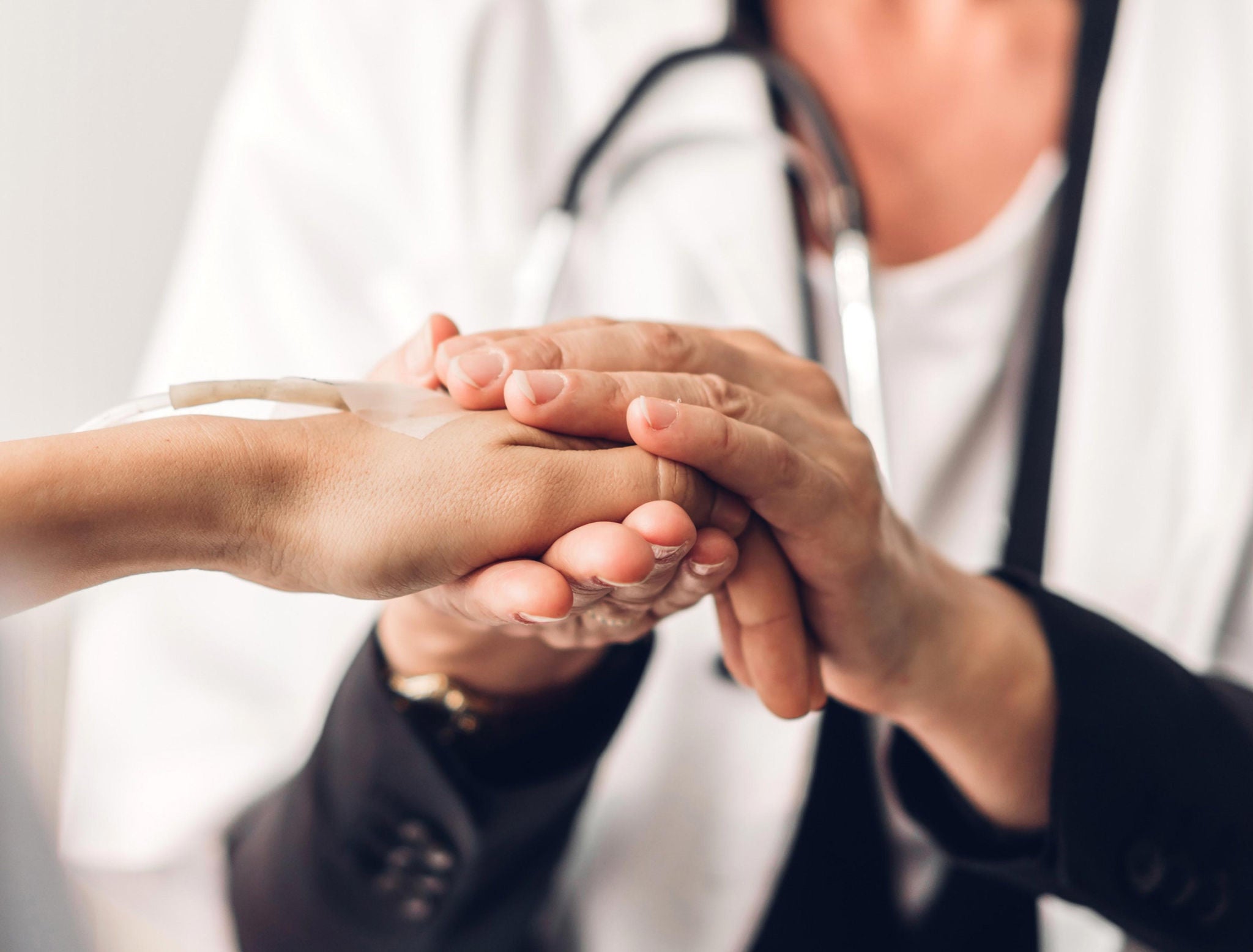 Doctor holding patient hand