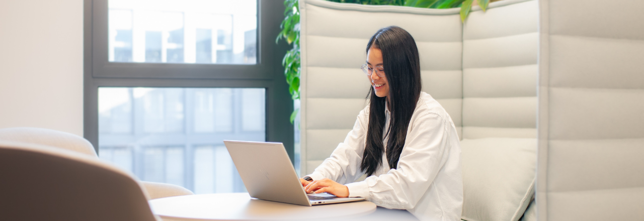 Boston Scientific employee smiling in a break area with green plants in the background