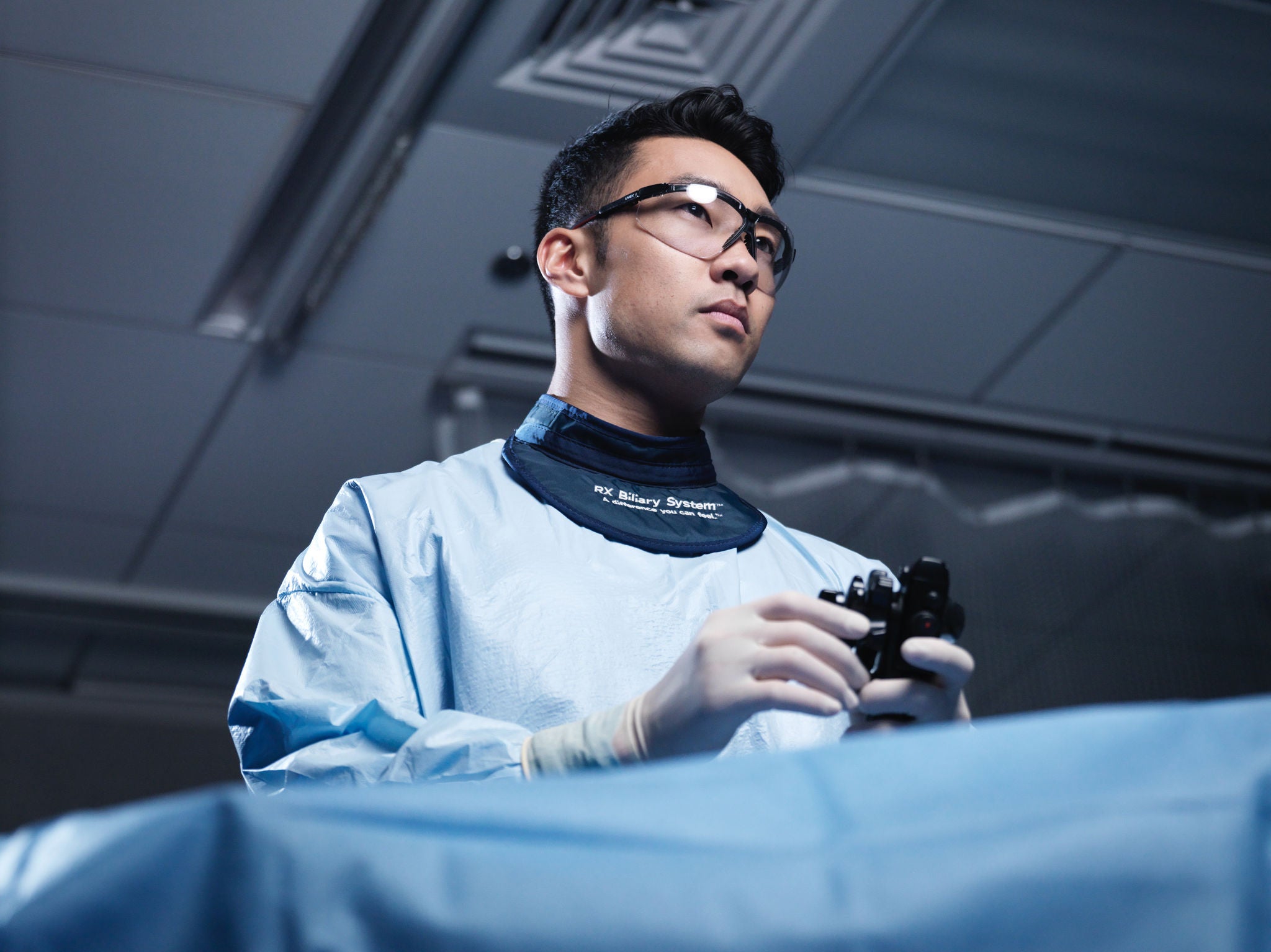 Healthcare provider using medical device in clinical setting.