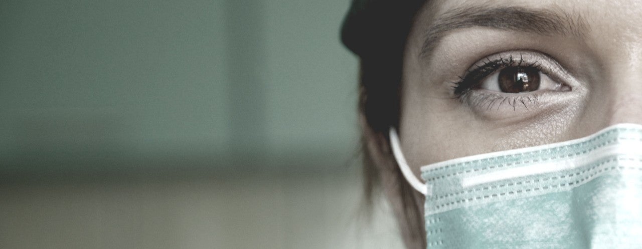 surgeon in mask looking at camera.