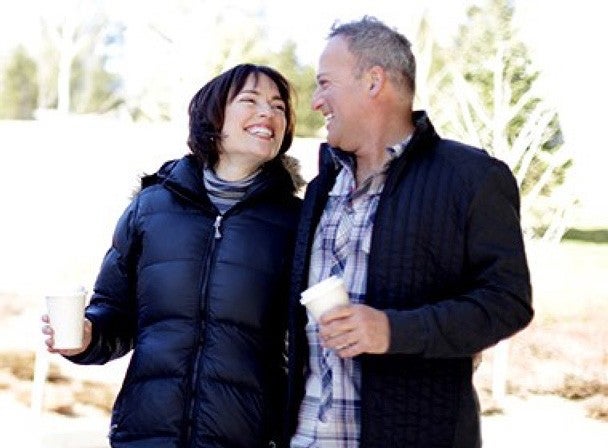 A couple in winter jackets embracing 