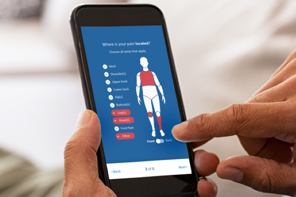 Hands using mobile phone with Pain.com website, with image of body with highlighted areas.