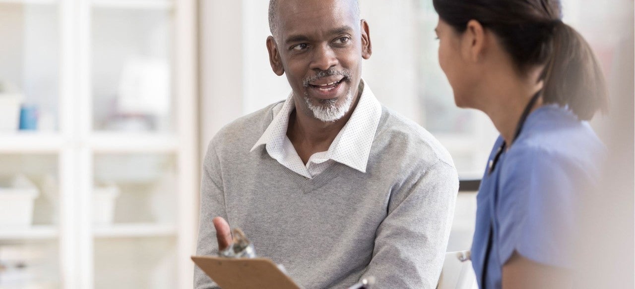 Doctor and patient reviewing information on a clipboard