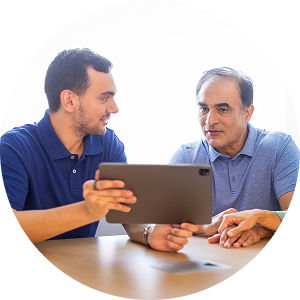 Rep and patient viewing a tablet.