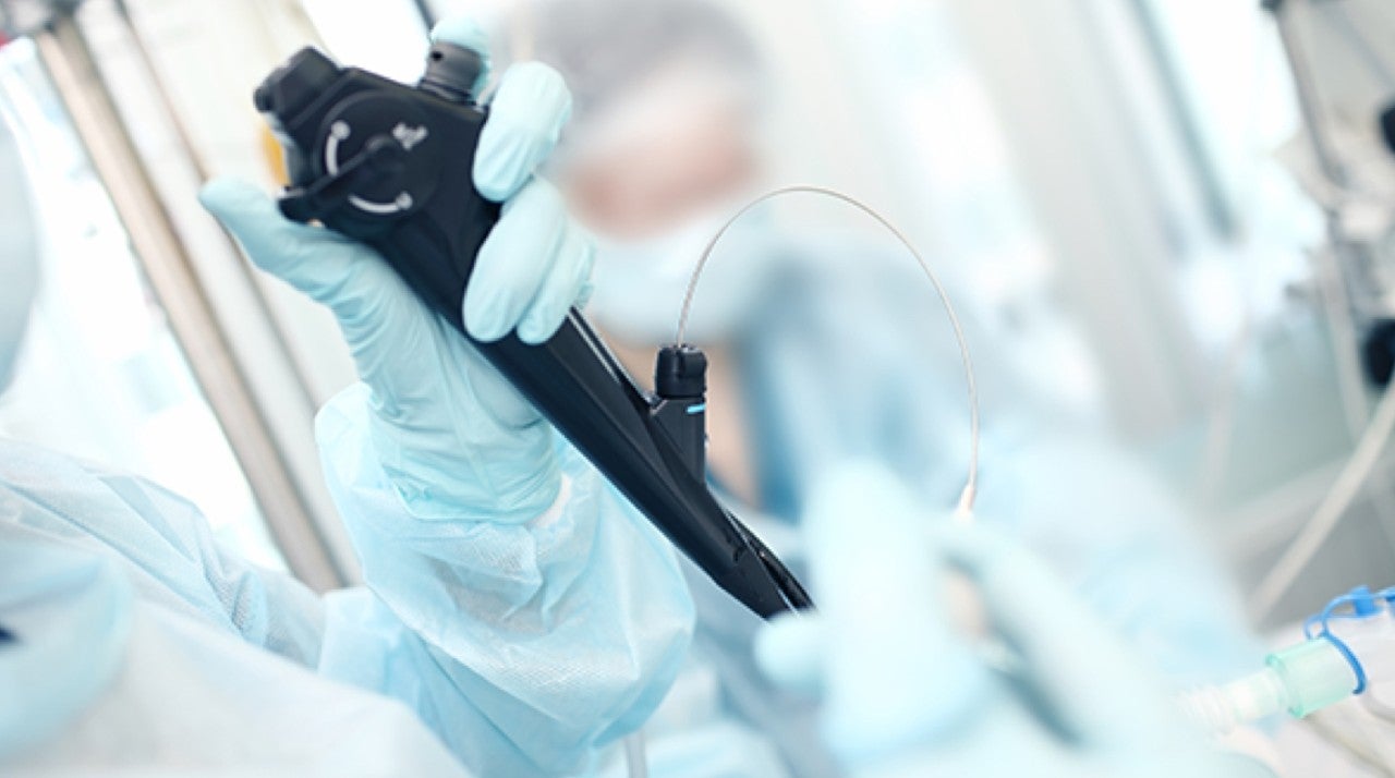 medical professional gloved hand holding medical instrument