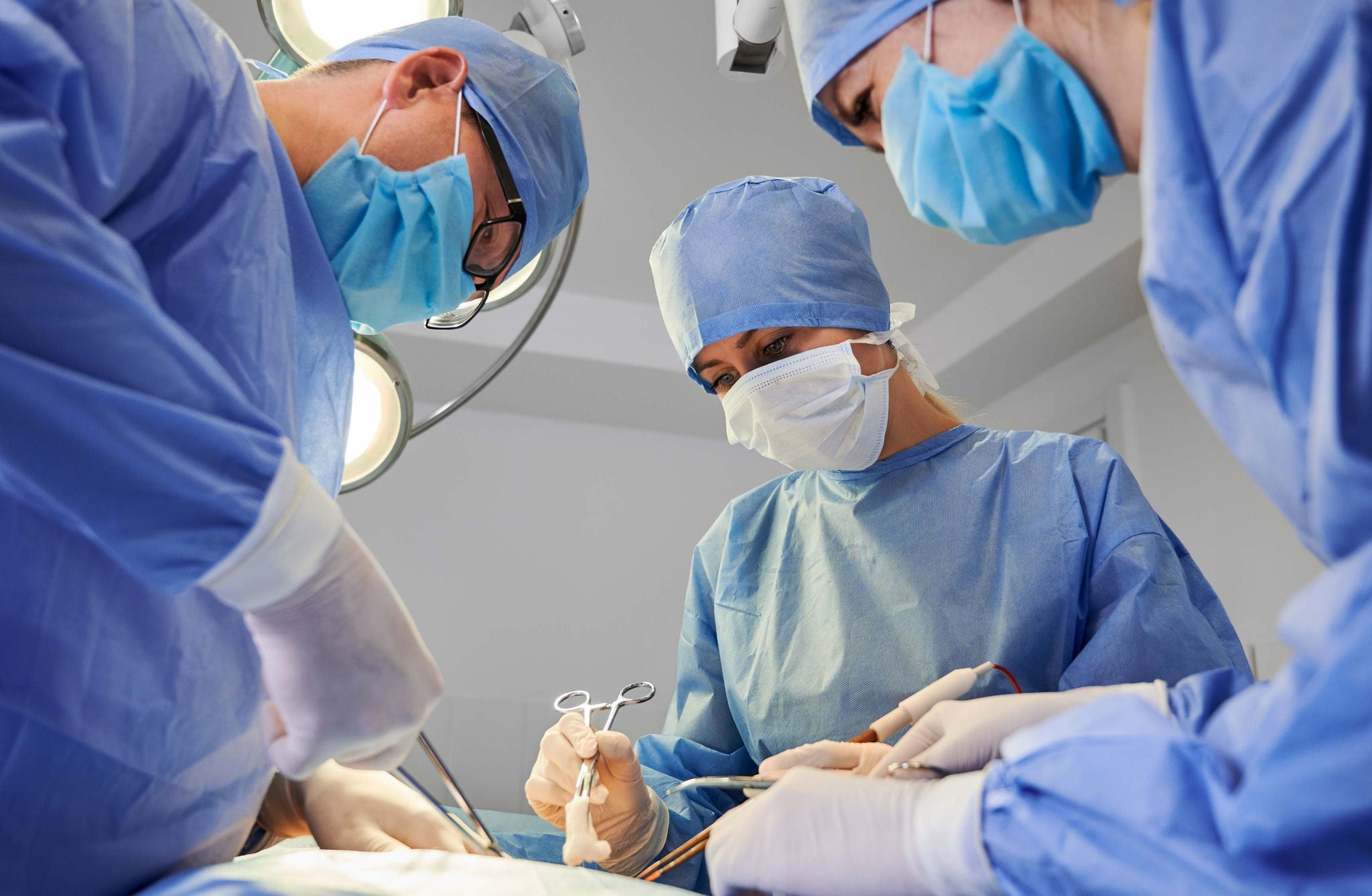 Doctor using stethoscope on patient