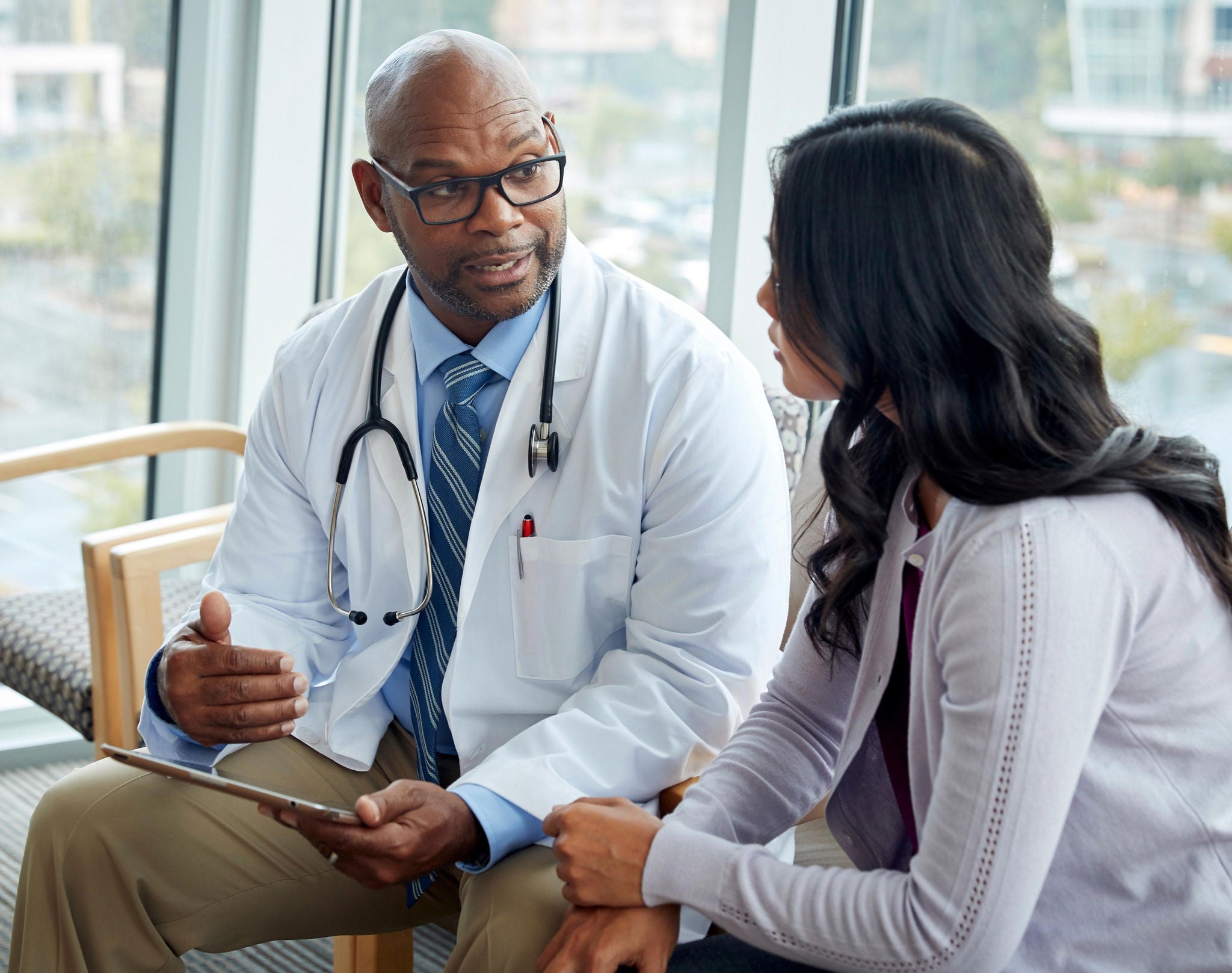Doctor using stethoscope on patient
