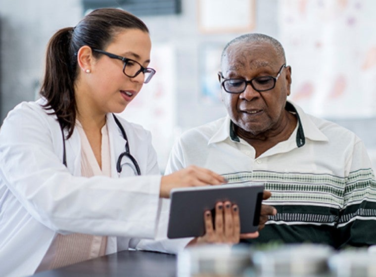 Doctor and patient reviewing a tablet