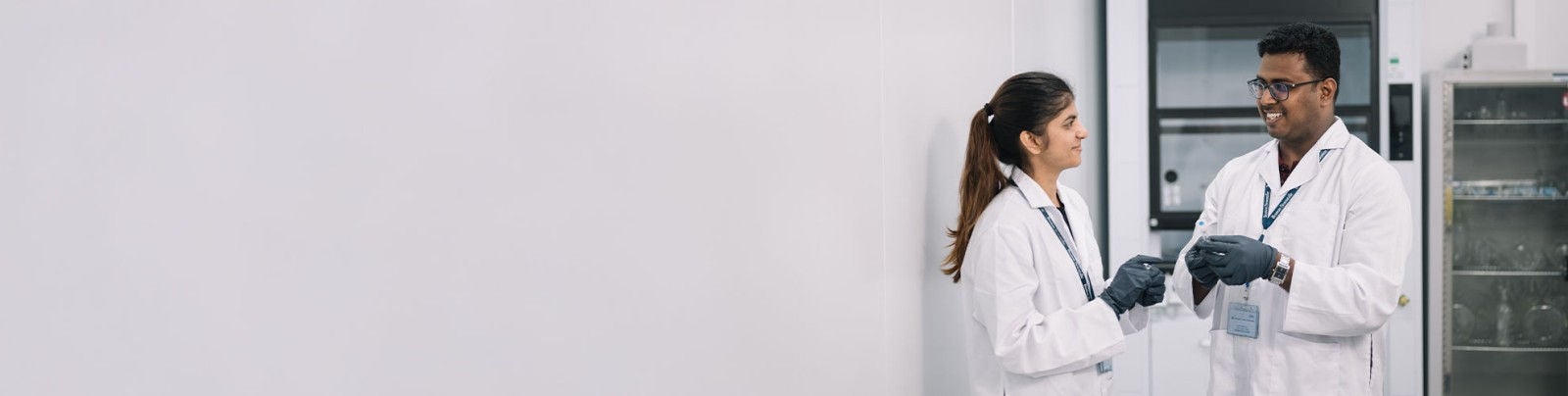 Boston Scientific employee in lab coat handling laboratory equipment