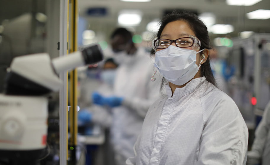 Physician in front of microscope