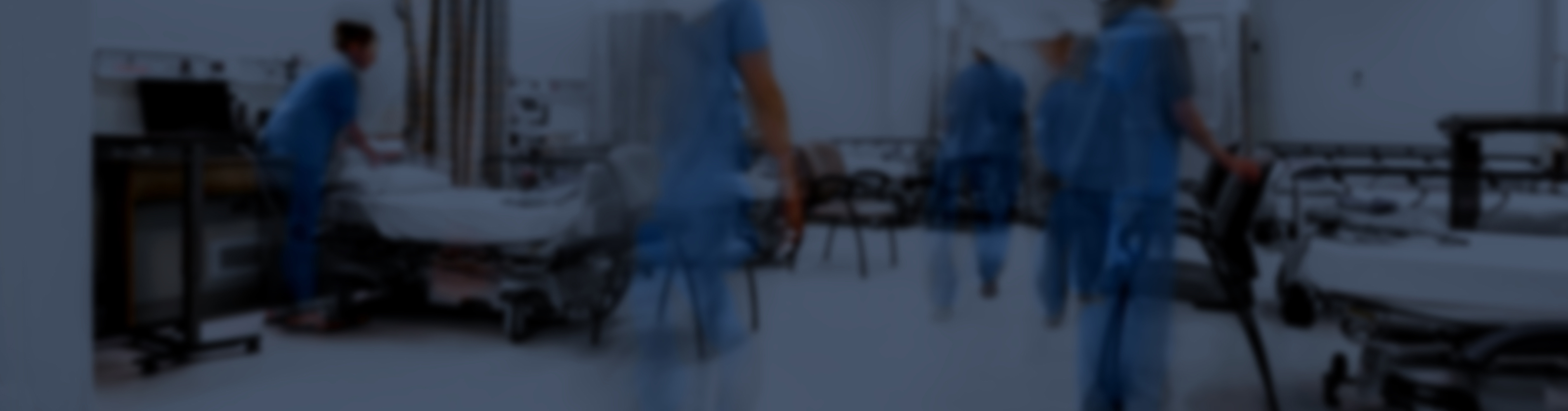 Fuzzy background image of healthcare professionals setting up large hospital room