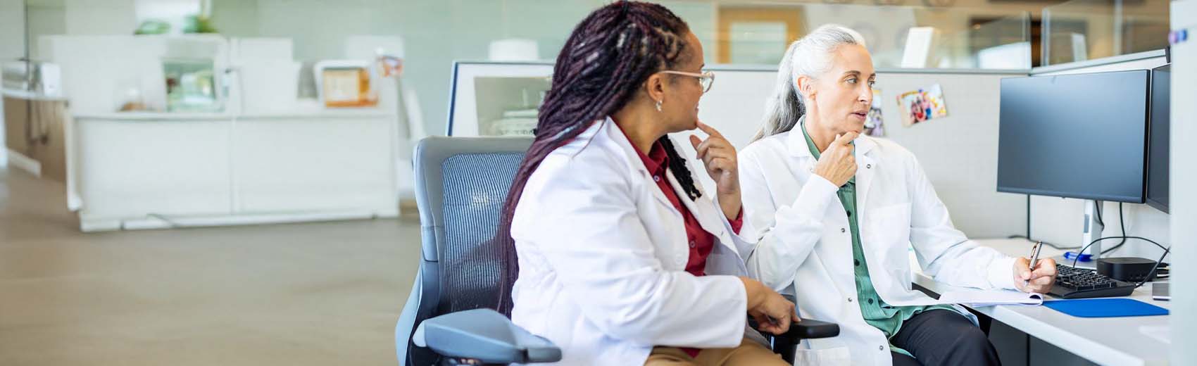 Medical specialists holding medical device.