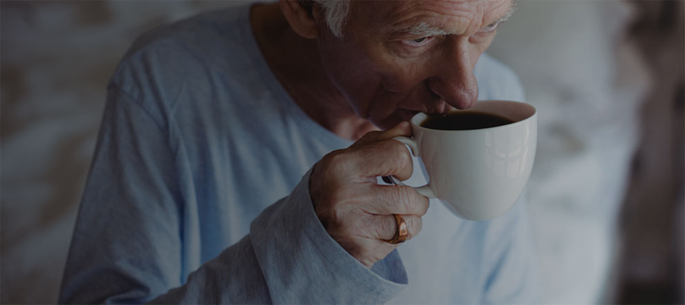 A Man Drinking Coffee in Bed