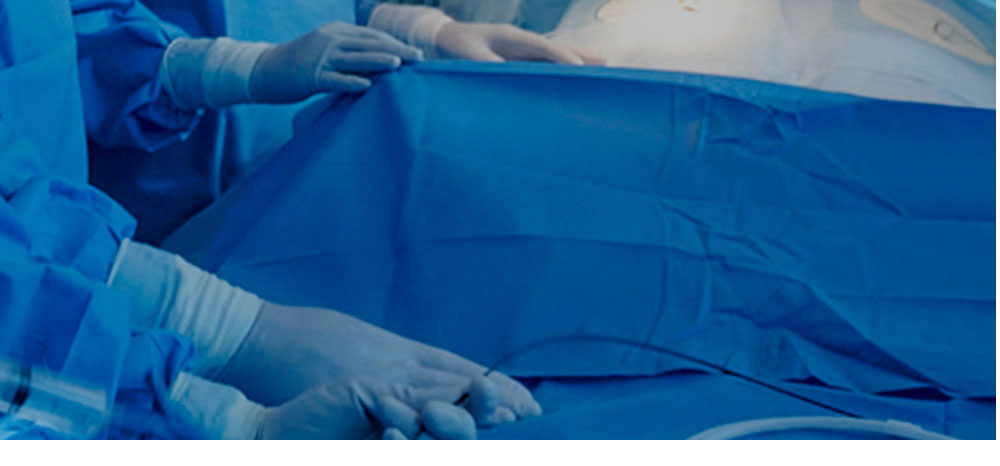 Medical staff gloved hands holding guidewire during surgery