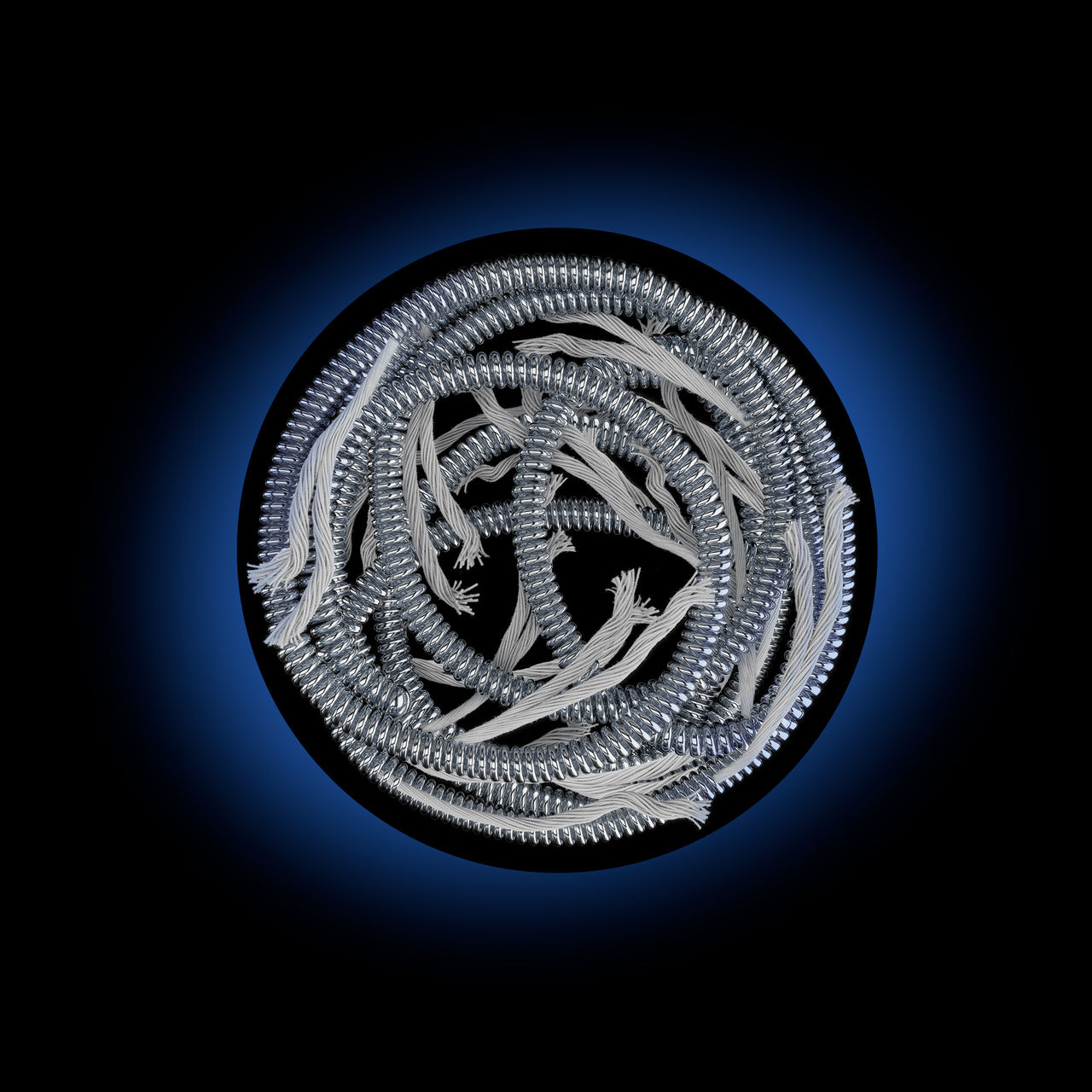 A fibered embolization coil packed in a vessel with a blue and black background.