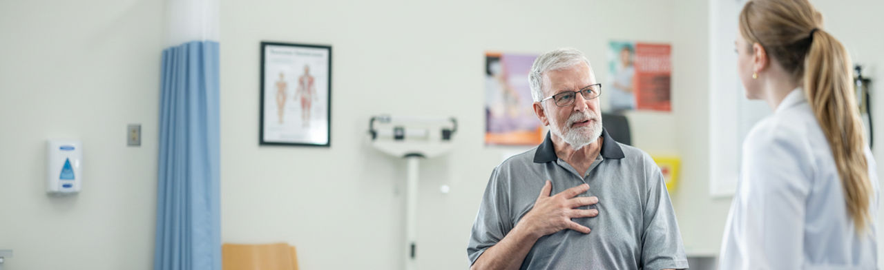 Senior patient speaking with healthcare professional during a medical consultation