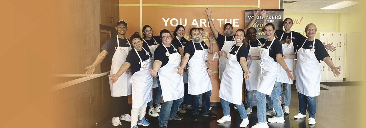 A group of Boston Scientific employee in apron outside canteen.
