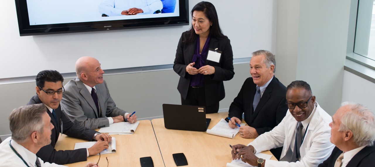 photo of roundtable of executives with presentation