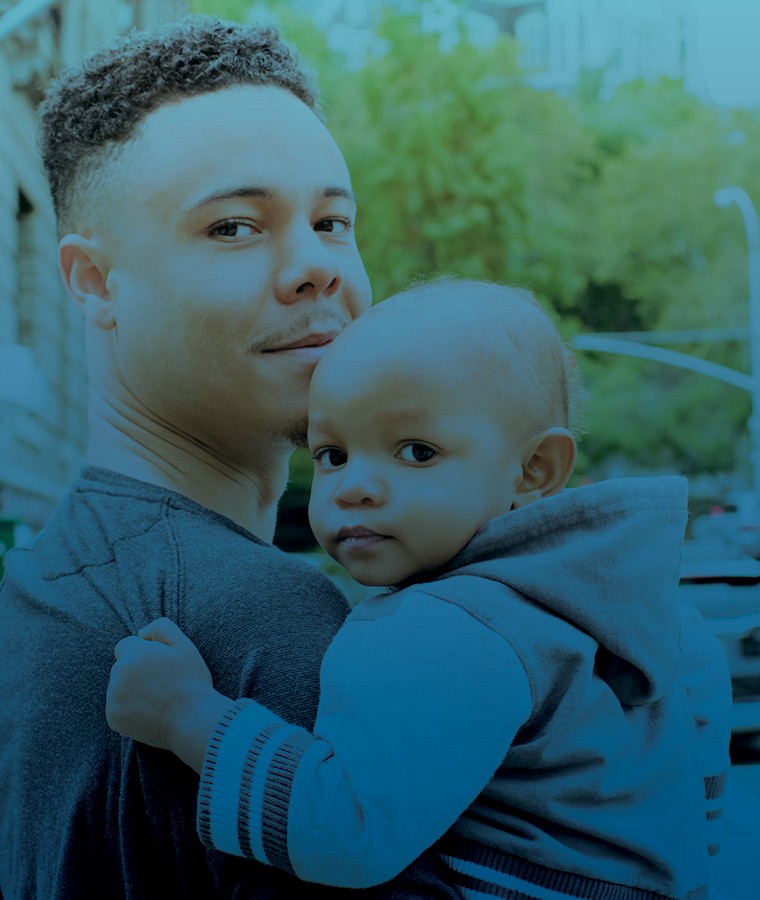 African American father holding young son