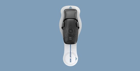 BodyGuardian Mini device in adhesive strip on blue background 