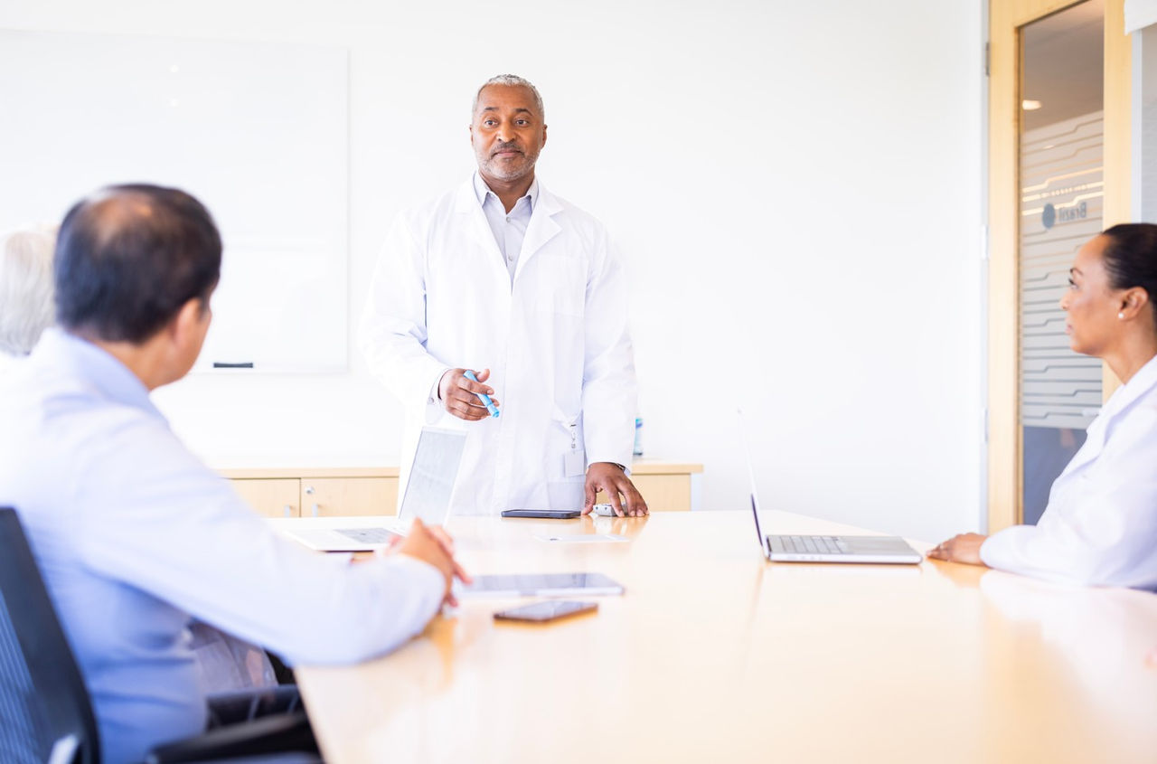 Presenter speaking in clinical meeting.