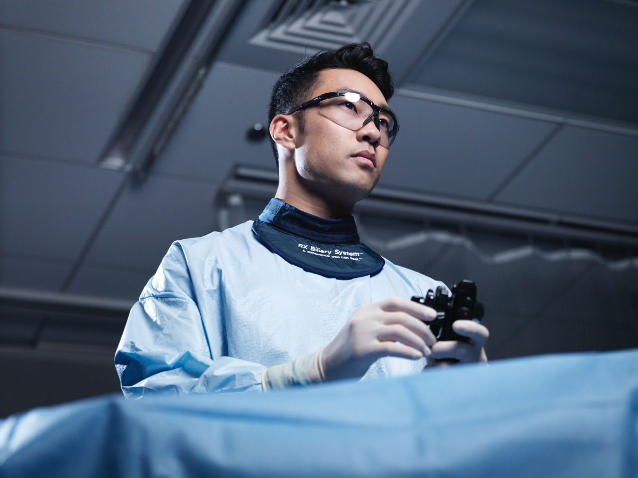 Healthcare provider using medical device in clinical setting.