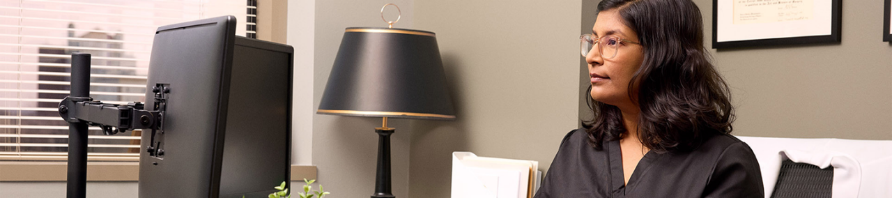 Healthcare provider working at computer.