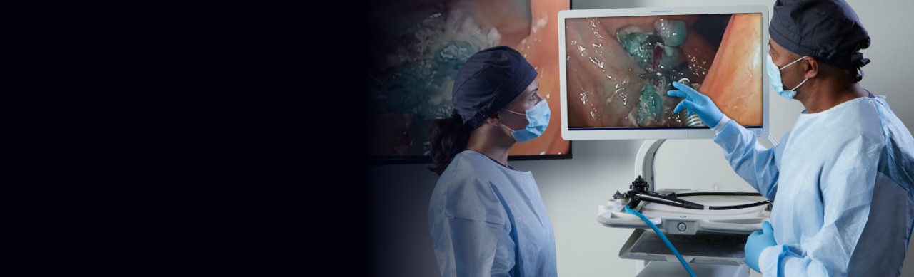 Two physicians review video image of MANTIS™ Clip closing a defect during an endoscopic submucosal dissection procedure