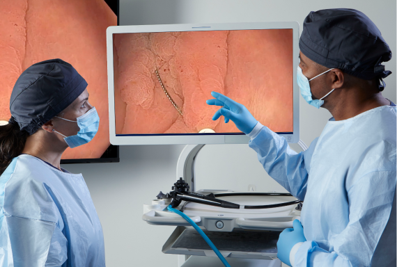 two health care professionals viewing endoscopic mucosal resection (EMR)