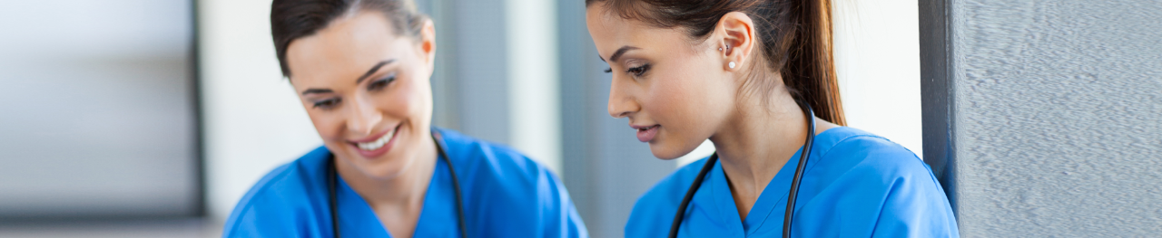 two nurses in scrubs talking