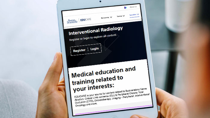 ipad with Boston Scientific Interventional Radiology page displayed, held by 2 hands.