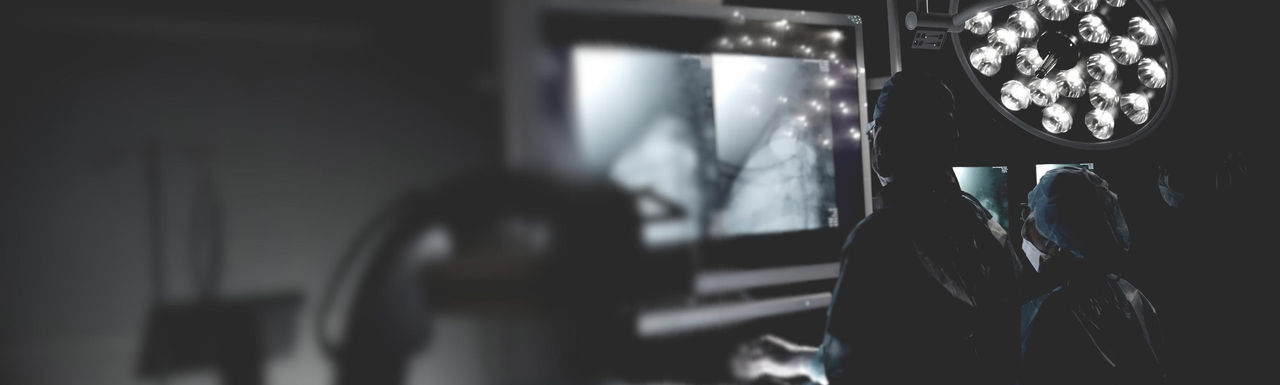 Surgeons viewing procedure on a monitor.