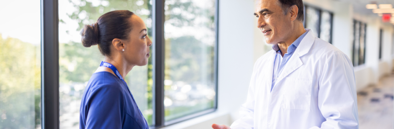 Boston Scientific rep talks with physician.