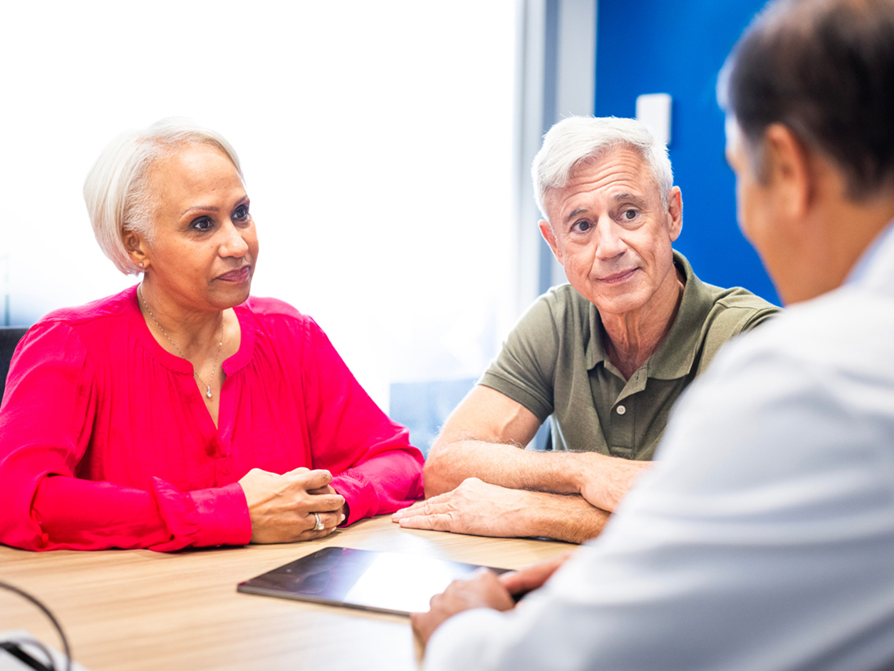 Older couple listening to a physician.