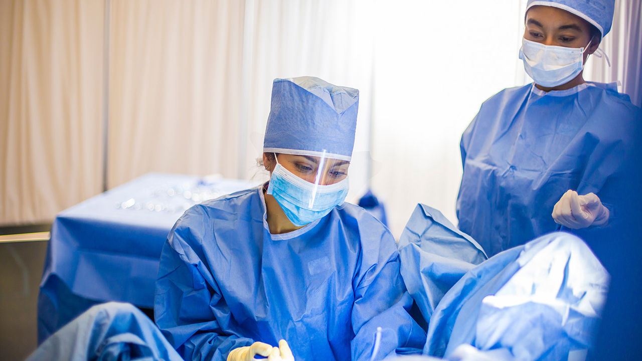 Healthcare providers wearing scrubs in OR.