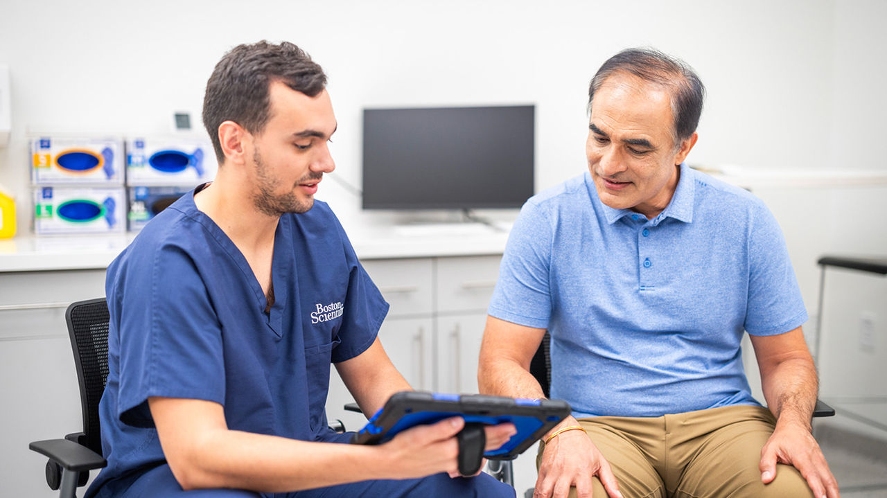 Physician talking to a male patient.
