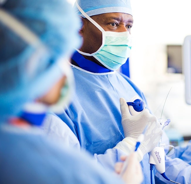 Male physician concentrating of surgical performance. 