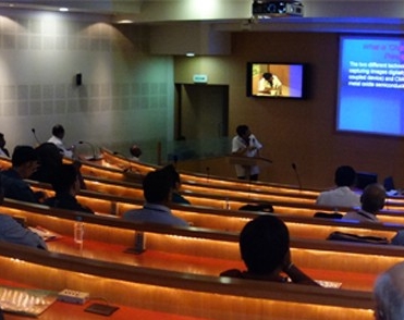 Lecture hall, during lecture, from the view of the audience. 