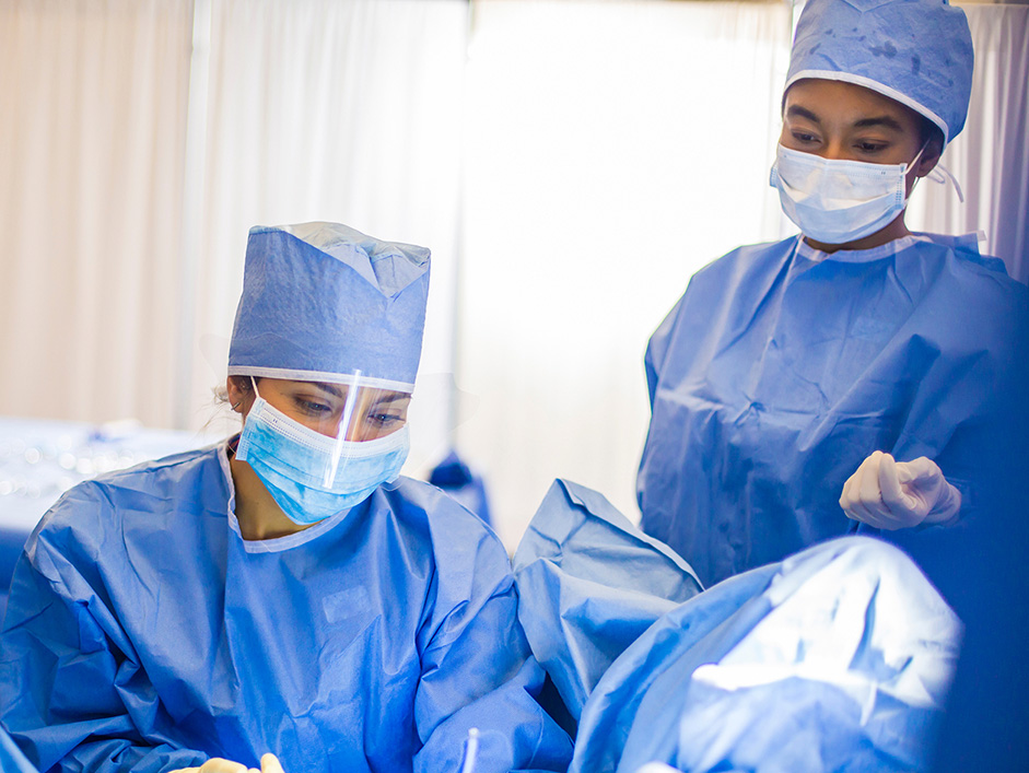 Two physicians in operating room.